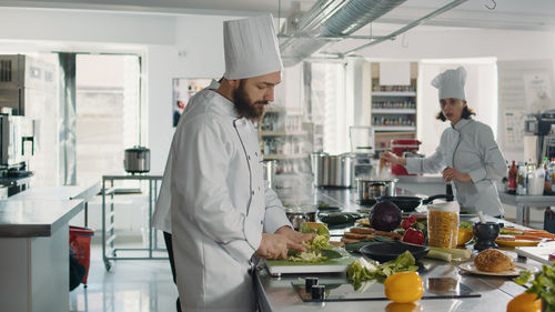 Side view of chef working in kitchen