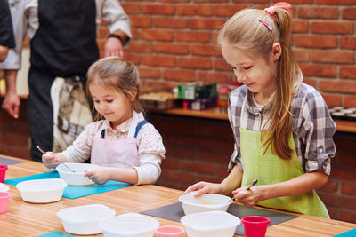 Girls learning cooking in class