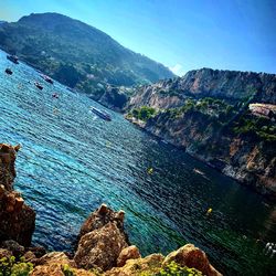 High angle view of sea and mountains against sky