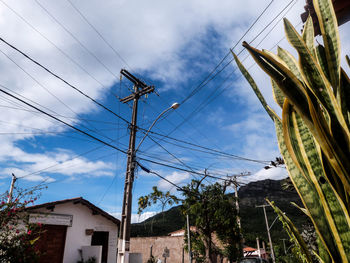 Low angle view of telephone pole and street light