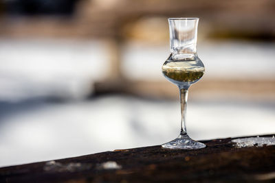 Close-up of wineglass on retaining wall