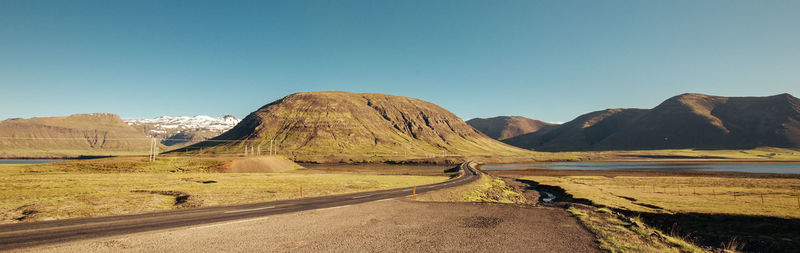 Scenic view of mountains against clear blue sky