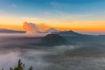 Scenic view of volcanic mountain against sky during sunset