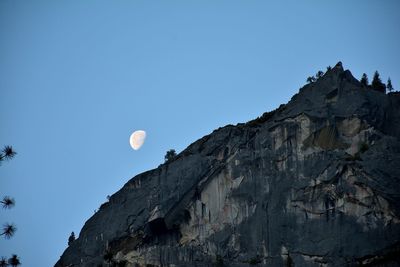 Low angle view of rock formation against clear blue sky