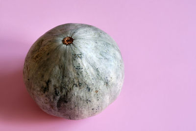 High angle view of apple against pink background