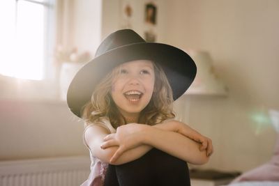 Portrait of a young girl laughing wither face painted and fancy dress