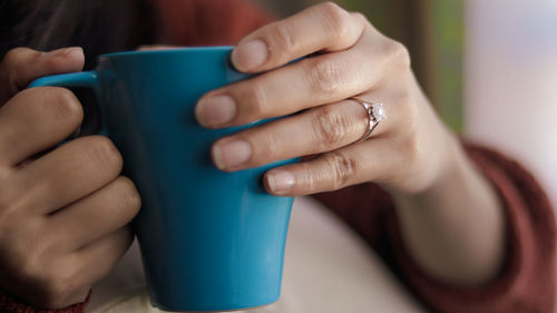 Close-up of woman holding coffee cup