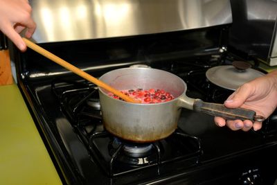 Midsection of man preparing food in kitchen