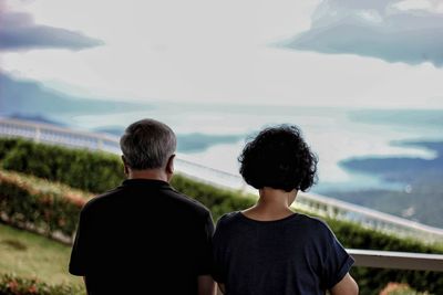 Rear view of couple at mountain against sky