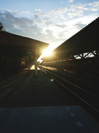 Railroad tracks against sky during sunset