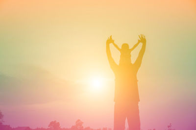 Silhouette person standing against sky during sunset