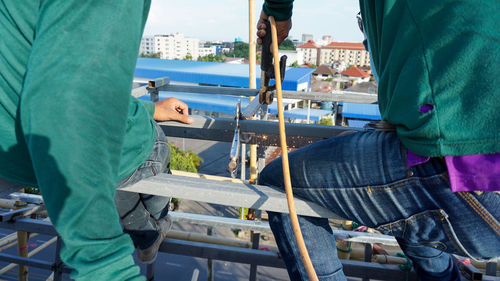 Low section of man standing in city