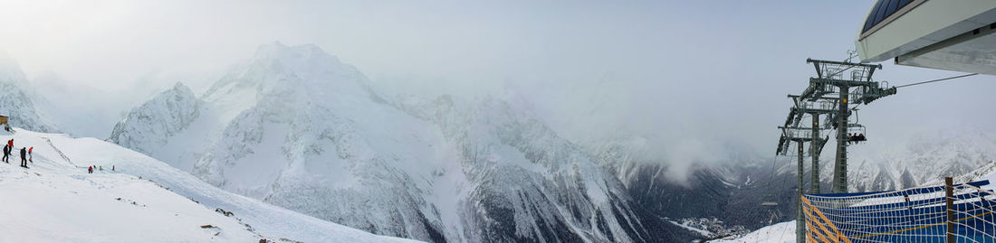 Panorama of the ski resort. on the left frame skiers and snowboarders,