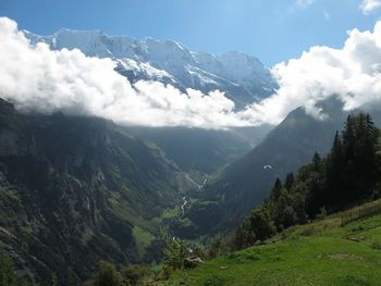 Scenic view of mountains against cloudy sky