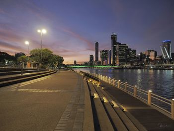 View of city by river against sky