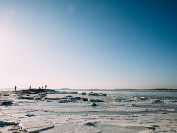 Scenic view of beach against clear blue sky