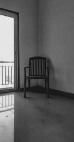 Empty chairs and table against wall at home