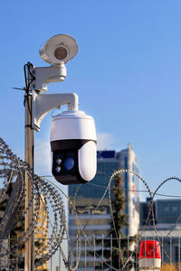 Video cameras with motion sensors monitor the security perimeter in the area fenced . 