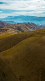 Scenic view of landscape against cloudy sky