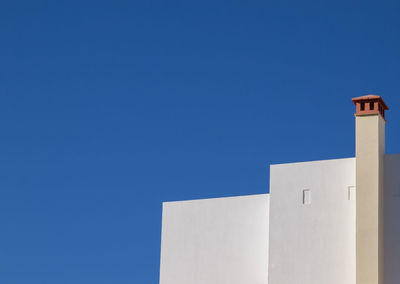 Low angle view of building against clear blue sky