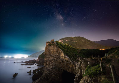 Scenic view of mountains against sky at night