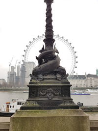 Statue of fountain in city against clear sky