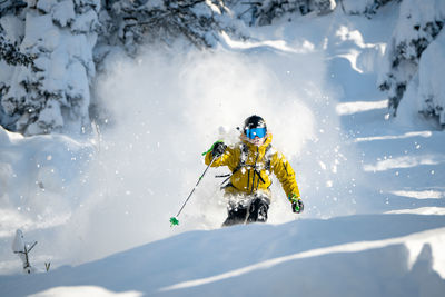 Adult man skiing in deep powder snow in the backcountry, werfenweng, austria.