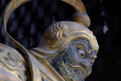 Close-up of statue at japanese temple during night