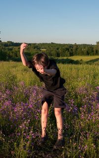 Full length of kid falling into meadow