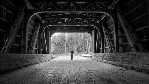 Rear view of man walking on footpath