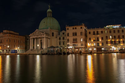 Reflection of buildings in city at night