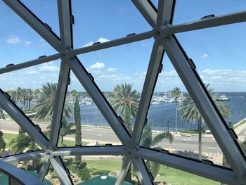 Low angle view of sea seen through glass window