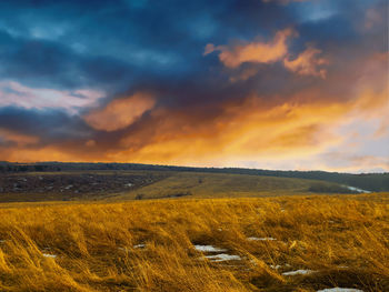 Scenic view of field against sky during sunset