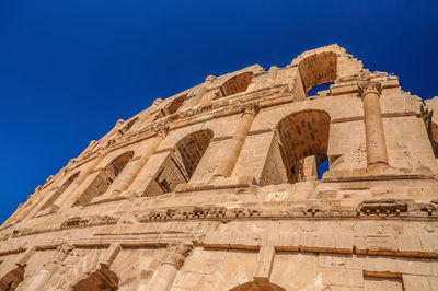 Low angle view of historical building against blue sky