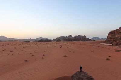 Man standing on rock in desert