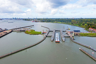 High angle view of bridge over river in city against sky