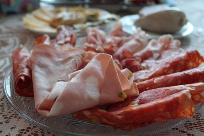 Close-up of various salami served in plate at table