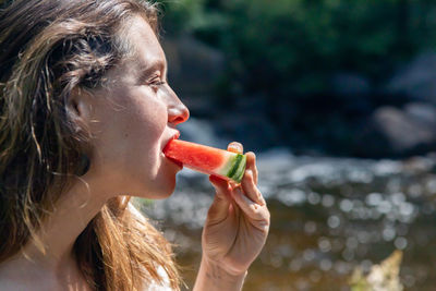 Close-up portrait of woman eating food