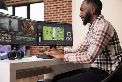 Side view of man working in office