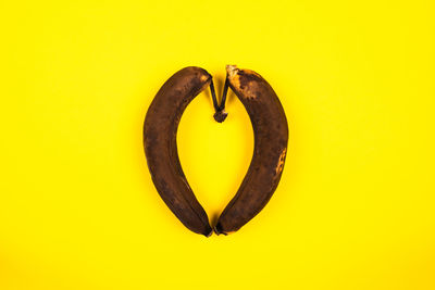 Directly above shot of heart shape on yellow background