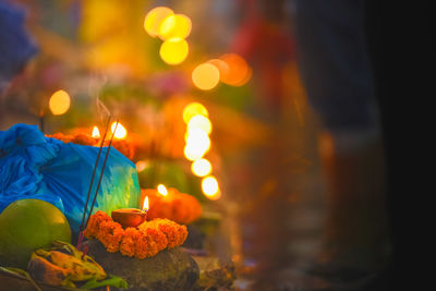 Close-up of illuminated candles on table