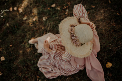 High angle view of girl holding toy on field