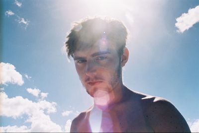 Portrait on young man against sky