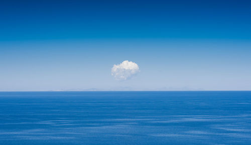 Scenic view of sea against blue sky