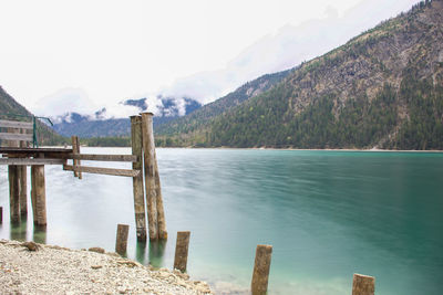 Scenic view of sea and mountains against clear sky