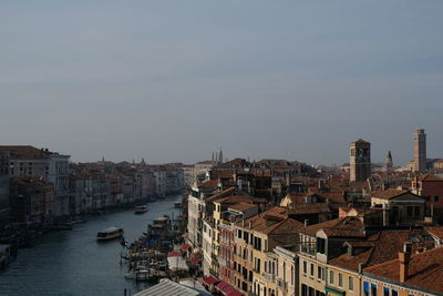 High angle view of buildings by canal against sky