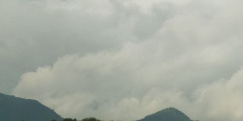 Low angle view of storm clouds over mountain