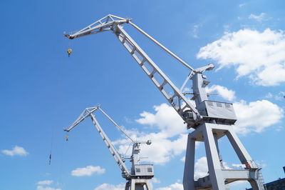 Low angle view of crane against sky