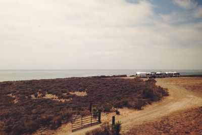 Caravans on field against sky