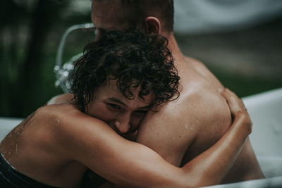 Couple in bathtub outdoors